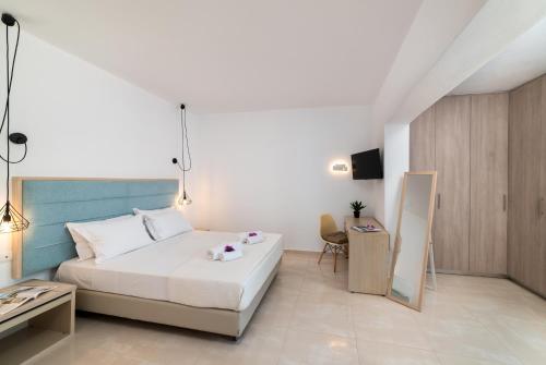 um quarto com uma cama, uma mesa e uma cadeira em Loft 57 em Agios Nikolaos