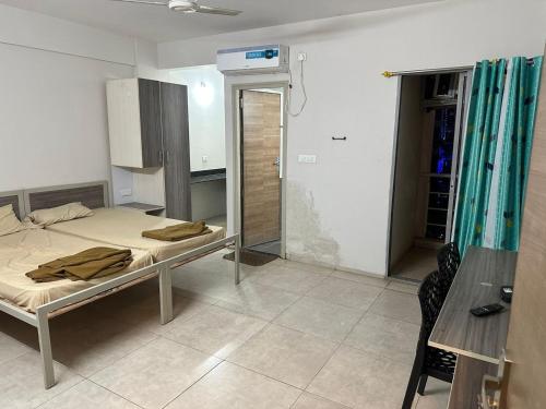 a hospital room with a bed and a bathroom at POP 82272C Townhouse Oak- Seven Olives in Bangalore
