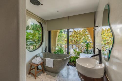 a bathroom with a large tub and a sink at Saha Casa Boutique Hotel Da Nang in Da Nang