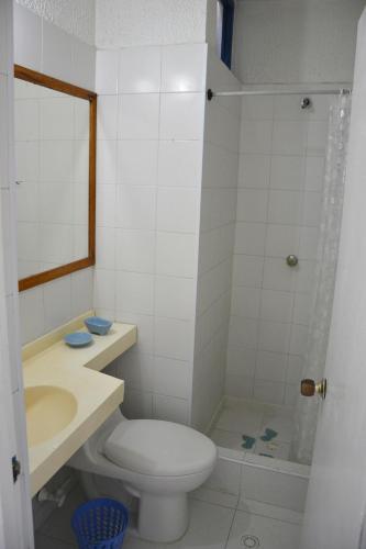 a bathroom with a toilet and a sink and a shower at El Camino Los Lanceros in Melgar