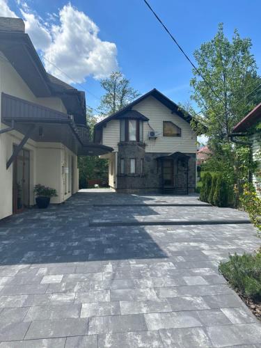 a stone driveway in front of a house at Cottage Zelman in Yaremche