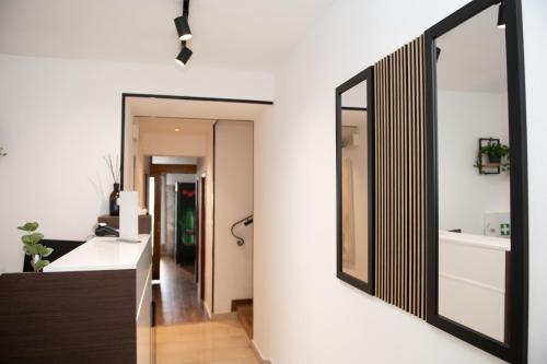 a bathroom with a large mirror on the wall at Hotel Marina in Fažana