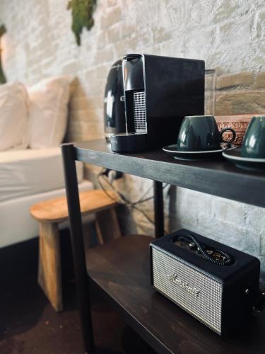a table with a microwave and a coffee maker on it at La Grainerie in Durbuy