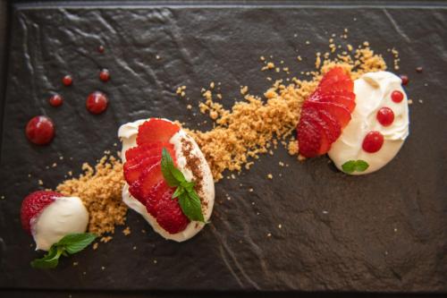 a dessert with strawberries and nuts on a table at Hotel Marina in Fažana