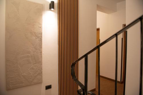 a hallway with a staircase with a light on the wall at Hotel Marina in Fažana