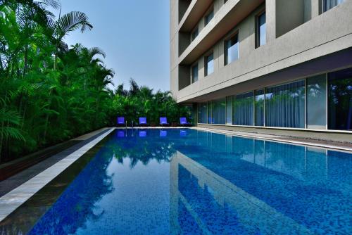 a swimming pool in front of a building at Courtyard by Marriott Pune Hinjewadi in Pune