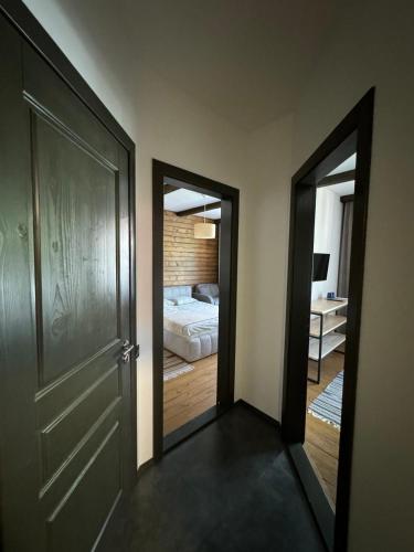 a hallway with two doors leading to a bedroom at Girske Povitria 2 in Yaremche