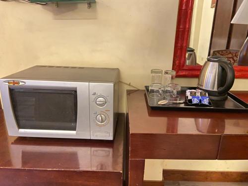 a microwave sitting on top of a table at Astoria Hotel in Kolkata