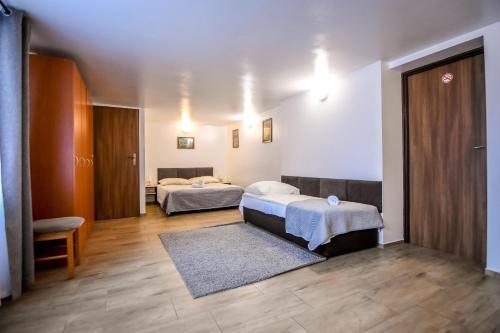 a hospital room with two beds and a rug at Willa Modra in Bukowina Tatrzańska