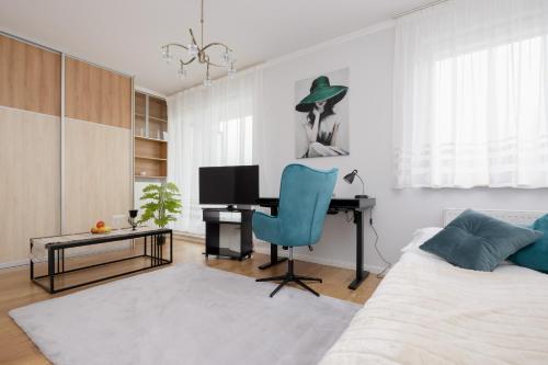 a bedroom with a bed and a desk with a computer at Bright Studio Głowackiego for 2 People in Warsaw by Renters in Warsaw