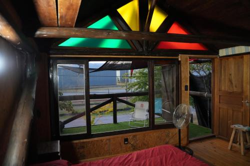 a stained glass window in a room with a bed at Cabaña Los Robles YOLI in Colonia del Sacramento