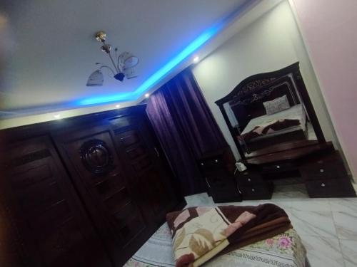 a room with a bed and a blue light at مدينتى in Madinaty