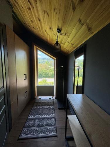 a room with a hallway with a table and a window at Girske Povitria 2 in Yaremche