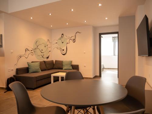 a living room with a couch and a table at Prasa in Piraeus