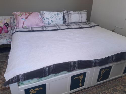 a bed in a bedroom with a white bed frame at For Your Vacations Only in Galatas