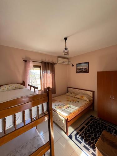 a bedroom with two bunk beds and a window at Hotel Elsaidi in Velipojë