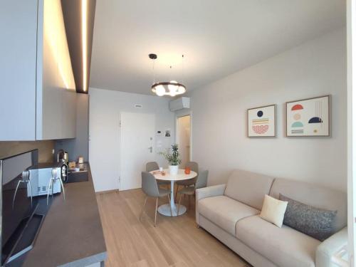 a living room with a couch and a table at Suite Exclusive a due passi dal mare posto auto in San Benedetto del Tronto