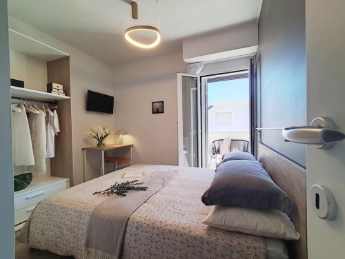 a bedroom with a large bed and a window at Suite Exclusive a due passi dal mare posto auto in San Benedetto del Tronto