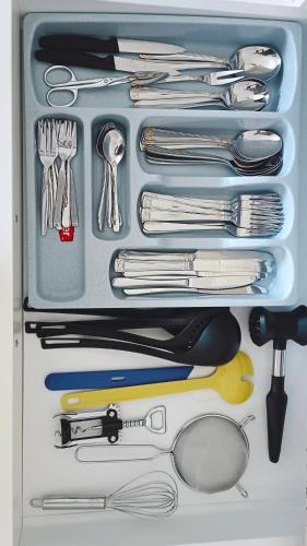 a drawer filled with lots of utensils and a drawer at Waldner's Ferienwohnung in Hermagor