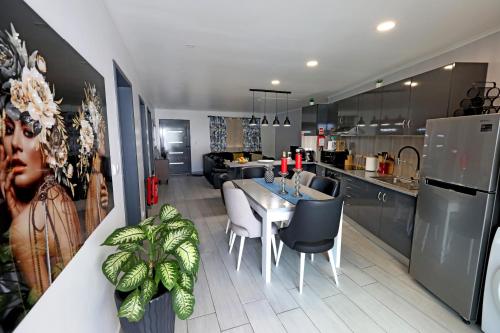 a kitchen and dining room with a table and chairs at Casa da Calheta in Maia