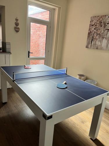 a ping pong table in a living room with at 4 bedroom, sleeps 8, 30 seconds from beach, games table in The Mumbles