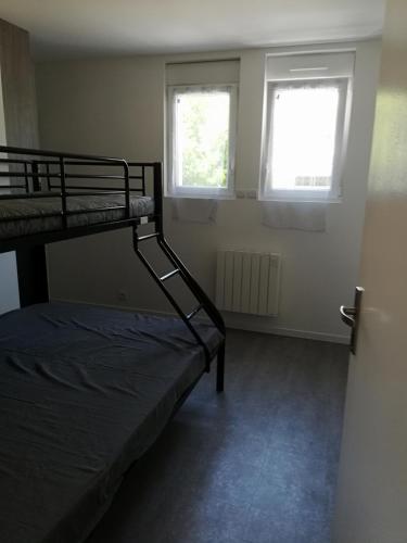 une chambre avec un lit superposé et deux fenêtres dans l'établissement Appart royan centre ville plage, à Royan