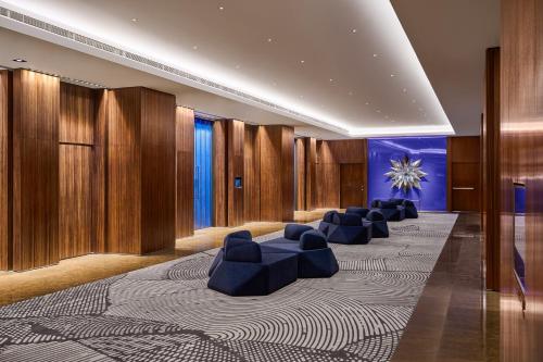 a lobby with blue chairs and wooden walls at W Taipei in Taipei