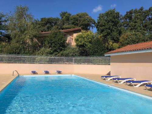 a swimming pool with lounge chairs and a house at T3 Georges Beljean - DABNB in Limoges