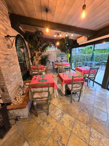 a restaurant with tables and chairs and a fireplace at Auberge les Aromes in Grasse