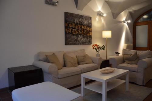 a living room with a couch and a table at Interno 23 Duomo Apartment in Udine