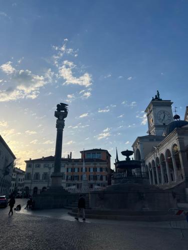a city square with a clock tower and a building at Interno 23 Duomo Apartment in Udine