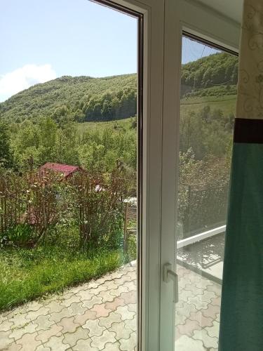 a sliding glass door with a view of a field at Casa Ozon in Vulcan