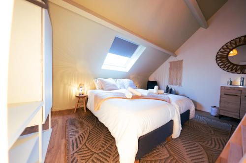 a bedroom with a large bed with a skylight at Lets Relax - Coté Nature in Mons