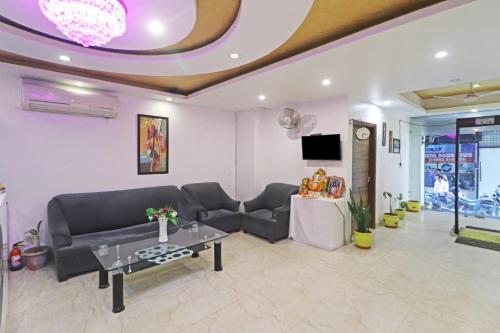 a living room with a couch and a table at Hotel Mint Residency - Dwarka Sector 9 in New Delhi