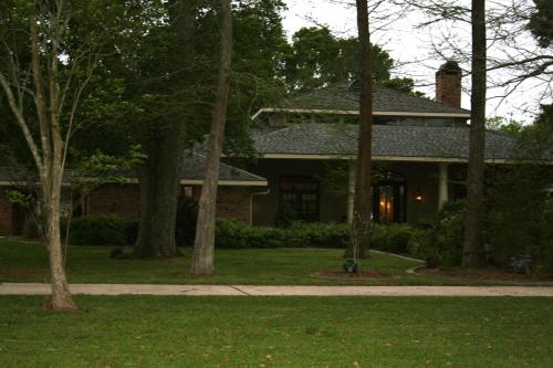 a house with a group of trees in front of it at Louisiana Cajun Mansion in Youngsville