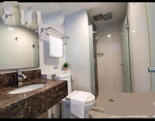 a bathroom with a sink and a toilet and a shower at Kk homeStay City suites Room Ming Garden Residence in Kota Kinabalu