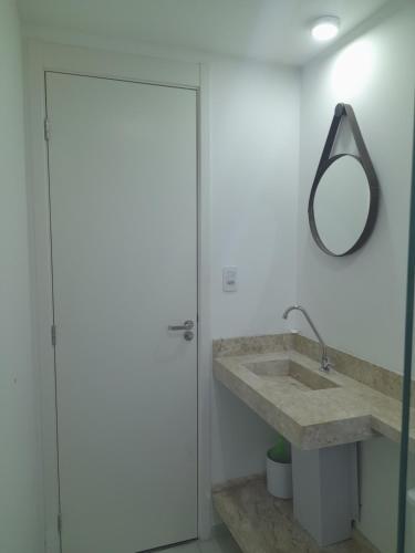 a bathroom with a sink and a mirror at All Liberdade (Liberdade/Se) in Sao Paulo