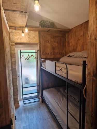a room with two bunk beds and a window at Two-Bedroom Cosy Country Lodge with Private Patio in Greenhithe