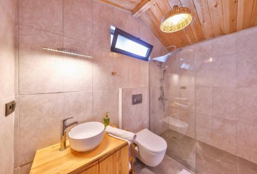 a bathroom with a sink and a toilet and a shower at Sedir Taş Evleri in Kalkan