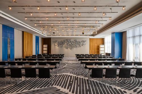 a banquet hall with tables and chairs in a room at W Taipei in Taipei