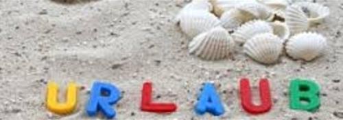 a group of shells on the sand with the words ucla at Meer-Brise in Burgh Haamstede