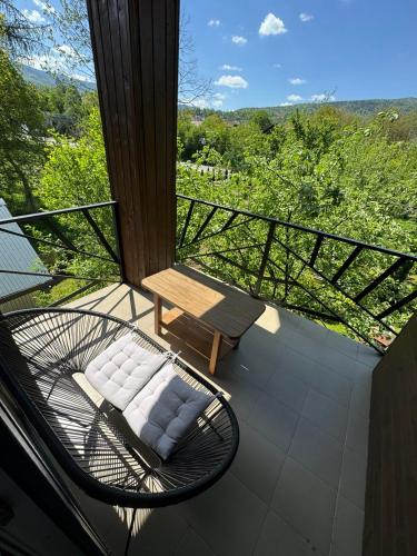 a balcony with a table and a bench on it at Girske Povitria 2 in Yaremche