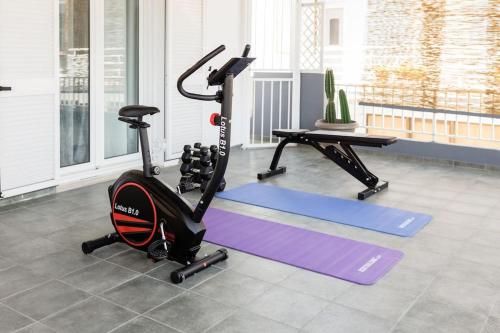 a gym with two exercise bikes and a treadmill at The Waves in Monodhéndrion