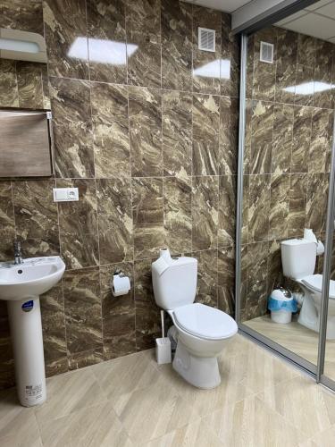 łazienka z toaletą i umywalką w obiekcie Motel Xameleon w mieście Voznesensk