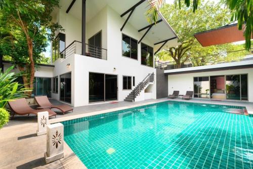 an image of a swimming pool in front of a house at Villa Pattara Rawai in Ban Saiyuan (1)