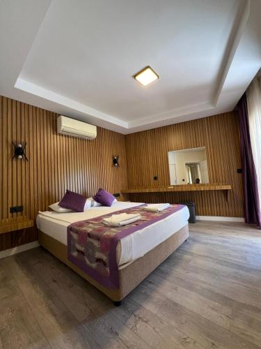 a bedroom with a large bed in a room at Sırma Family Apart Hotel in Side
