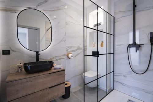 a bathroom with a sink and a mirror at Villa Malost in Hyères
