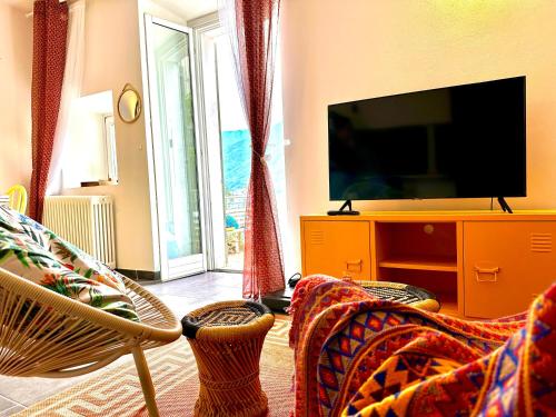 a living room with a flat screen tv and a couch at La casa sulla collina - apt. 1 in Colonno