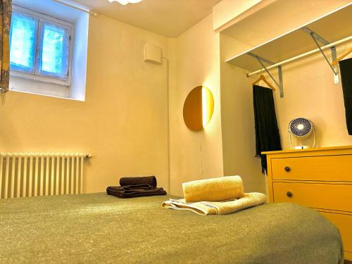 a bedroom with a bed and a dresser and a window at La casa sulla collina - apt. 1 in Colonno