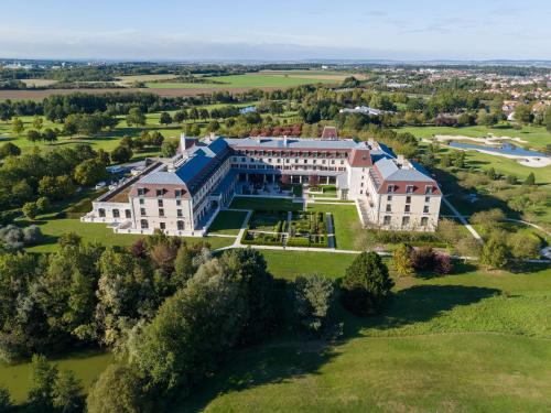 an aerial view of a large building on a green field at Radisson Blu Hotel Paris, Marne-la-Vallée in Magny-le-Hongre